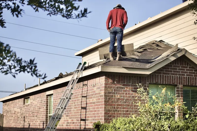 Professional roofer working on a residential roof in Lower Montville